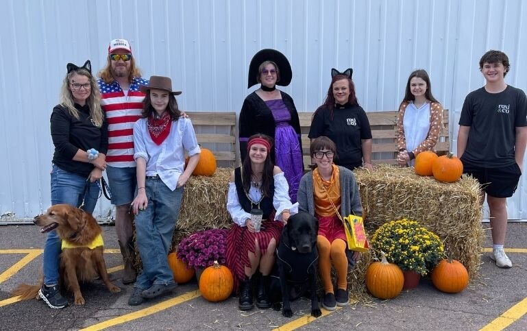 Roxi & Co team in costume at a Halloween event, showcasing fun and community culture.