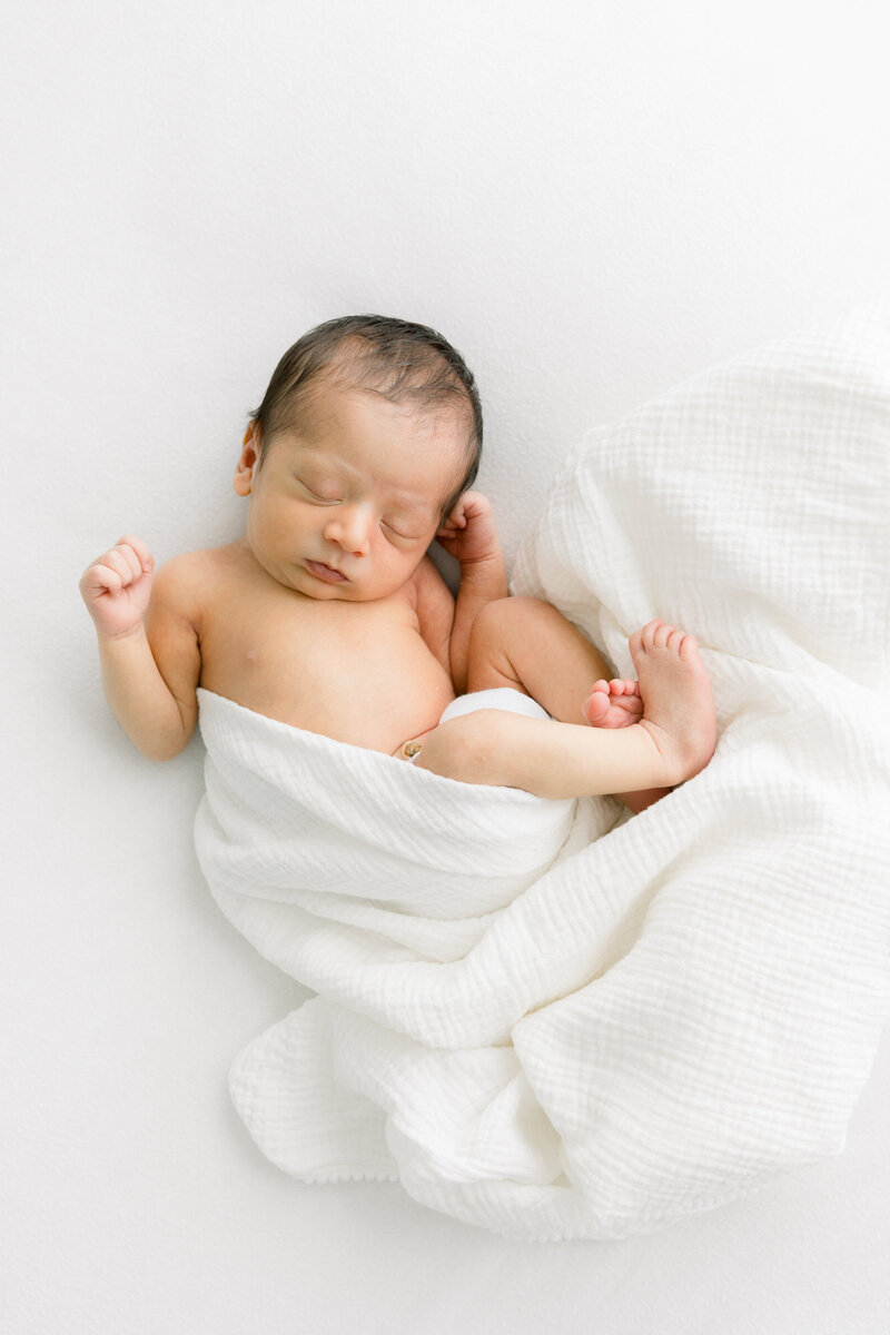 a pregnant woman with her arm linked around her husband's