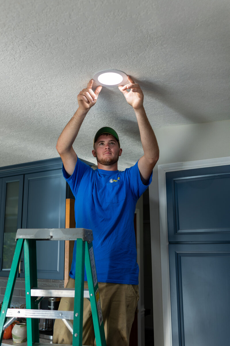 Residential electrician in Iowa providing kitchen electrical repairs and lighting installation services.