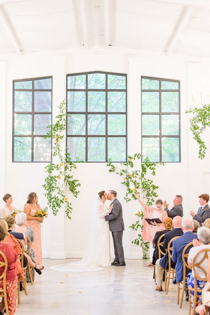 A couple shares their first kiss at the Distillery wedding venue.