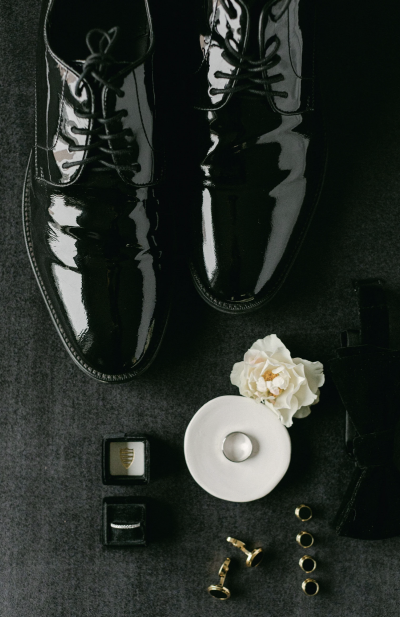 Black velvet styling mat with dramatic florals and luxury wedding stationery