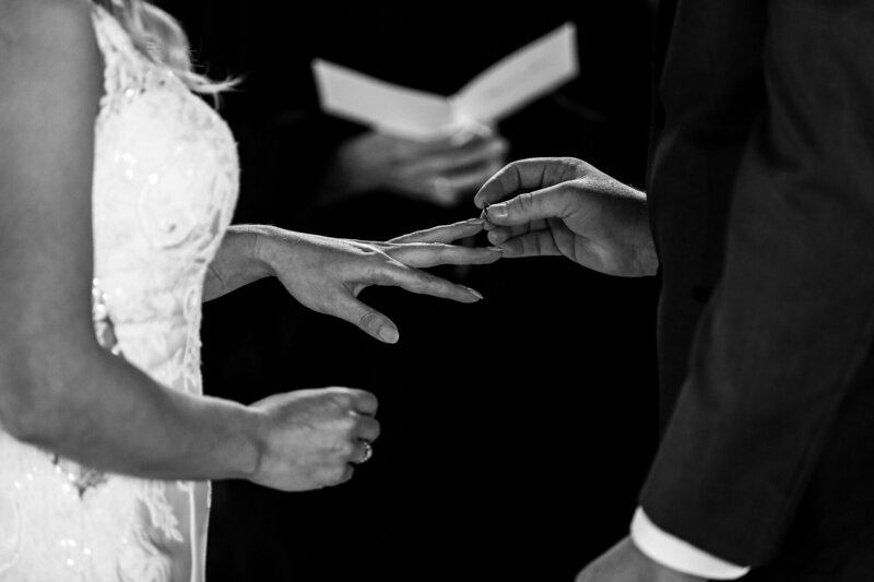 Couple exchanges rings during wedding ceremony at Quincy Cellars