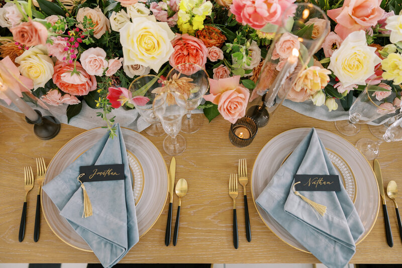 Wedding decor with place settings and colorful floral decor