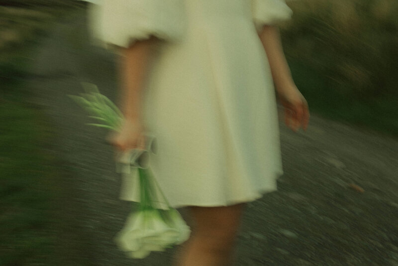 blurry photo of bride with calla lilies and sunglasses