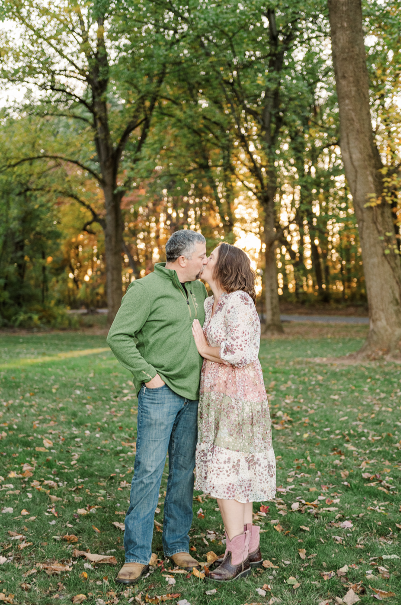 family session at spring valley farms york pa husband and wife sharing a kiss in golden light