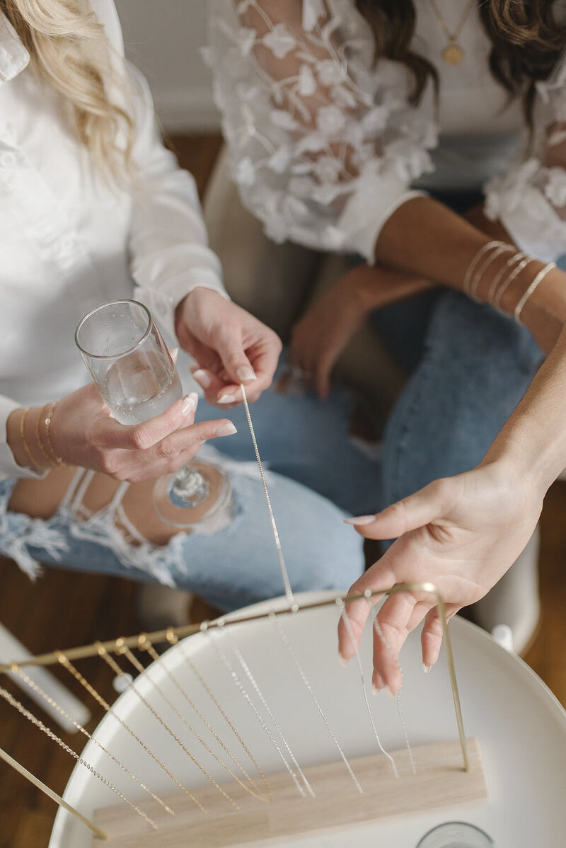 women holding onto jewelry