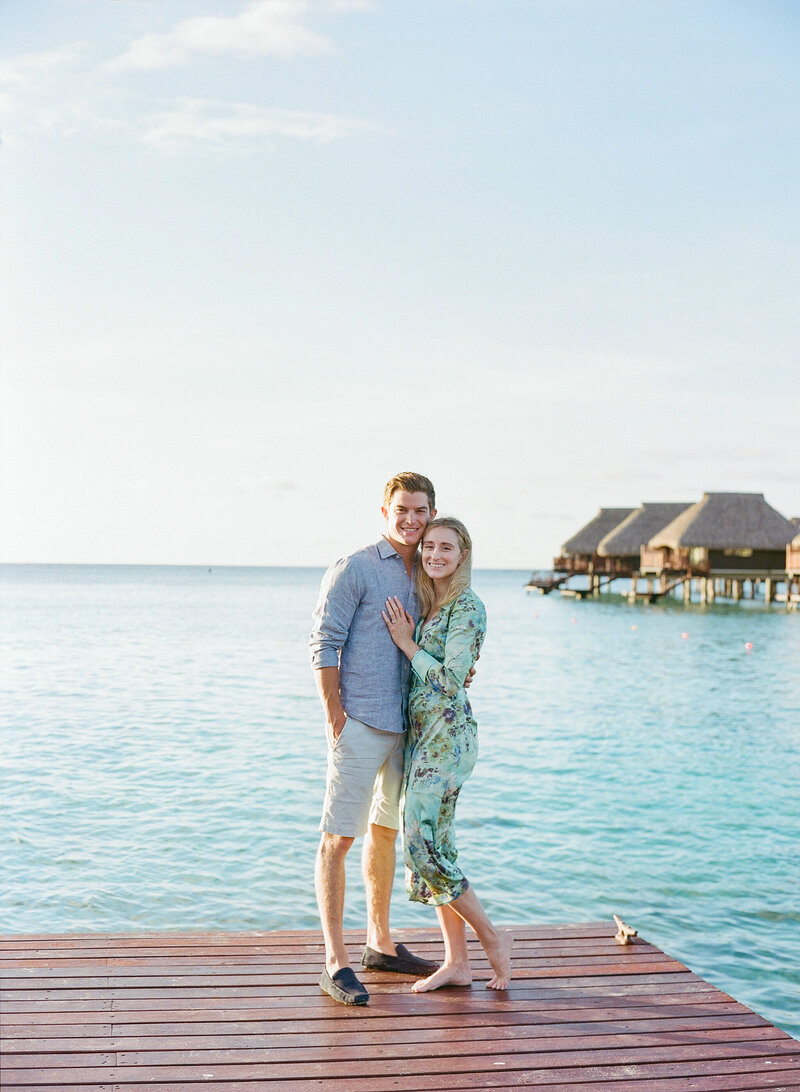 Couple walking playing at sunset in the Four seasons bora bora on the beach