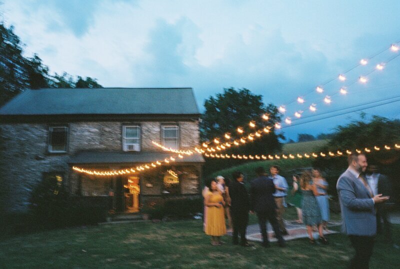 Bride and groom kissing on playground by candid wedding photographer Noble Photo Co