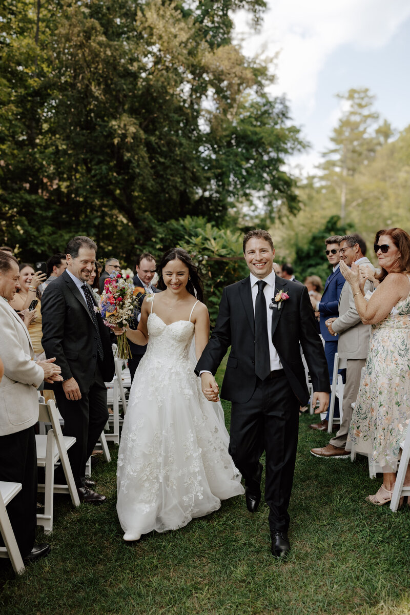 groom embraces bride after wedding in new hampshire