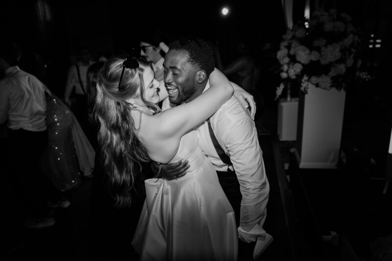 A bride and groom dancing at their wedding reception in a black and white photo at the Ben, Autograph Collection in West Palm Beach.
