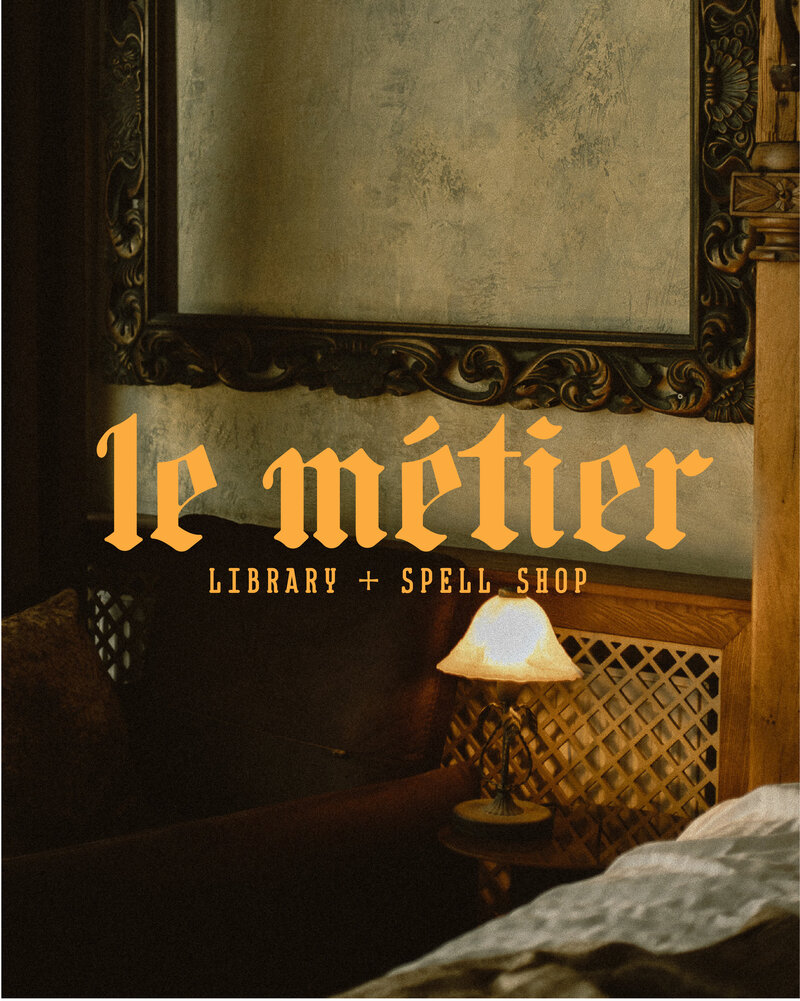 dark academia seating area with a logo for le metier library and spell shop