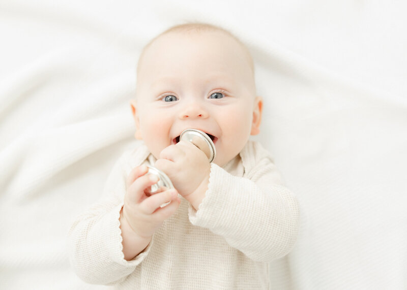 Baby smiling at camera for milestone portrait by Northern Virginia Baby Photographer