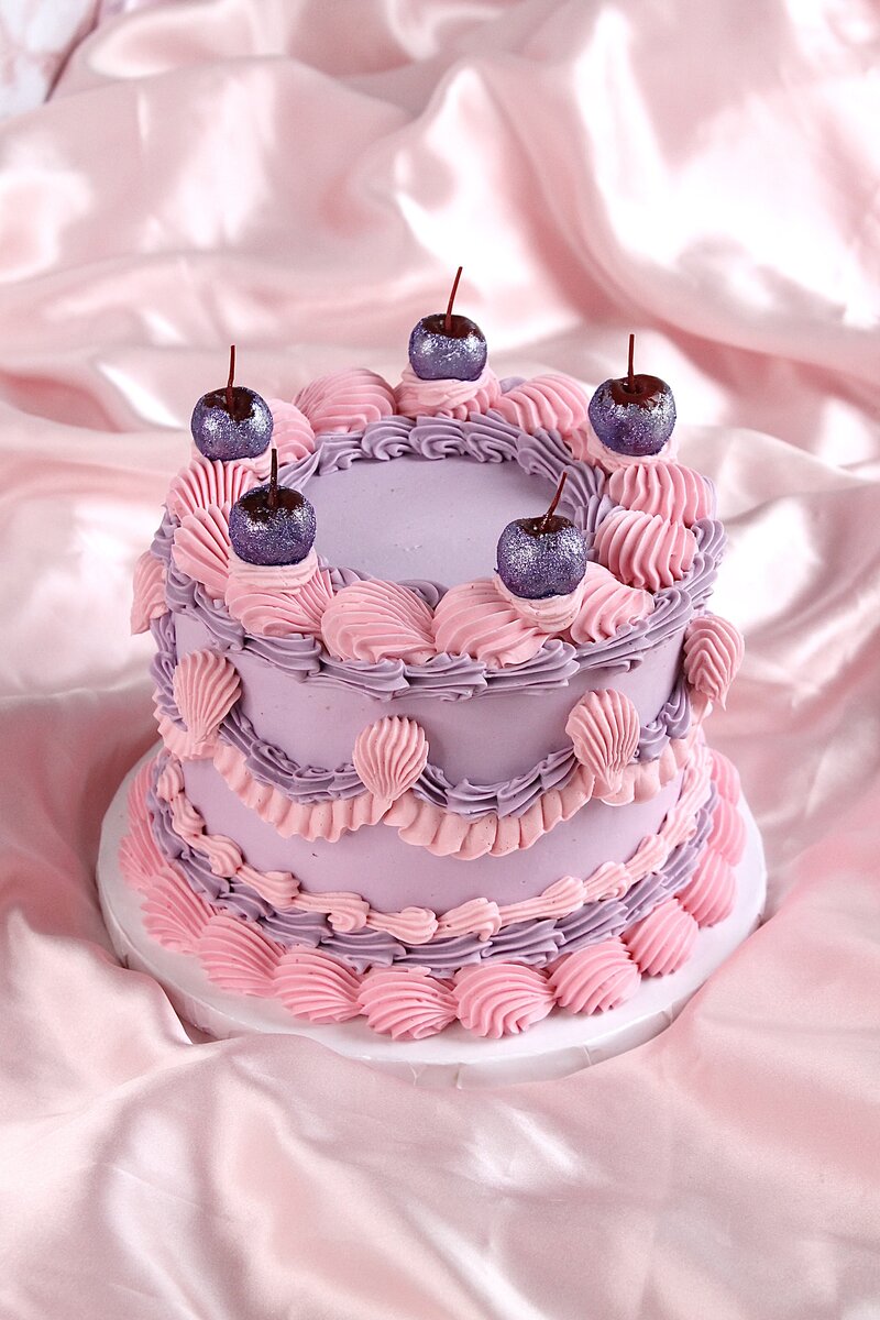 Pink cake with frosting and gold butterflies