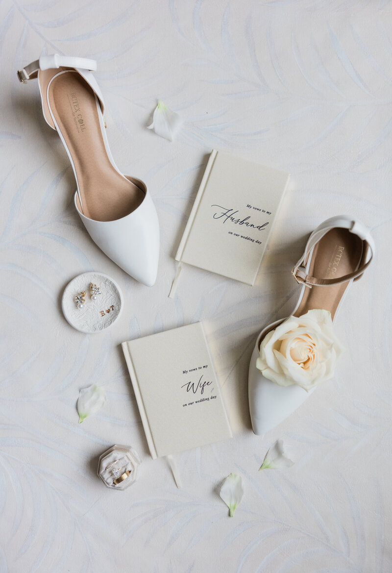 A creative flat lay image of a wedding detail photo of shoes and vow books in West Palm Beach.