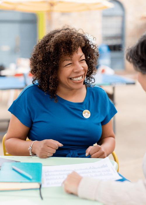 Photo of Michelle McKown-Campbell  and a female client  smiling during a coaching session