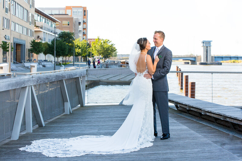 bride and groom see each other for the first time wedding day first look on pier near detroit river