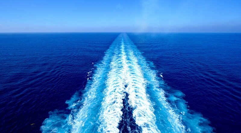 waves from behind an ocean cruise ship in the open waters