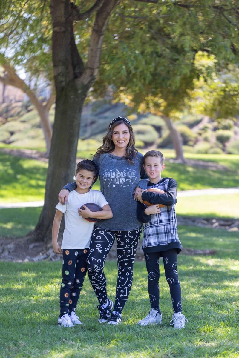 mom with her two sons under tree