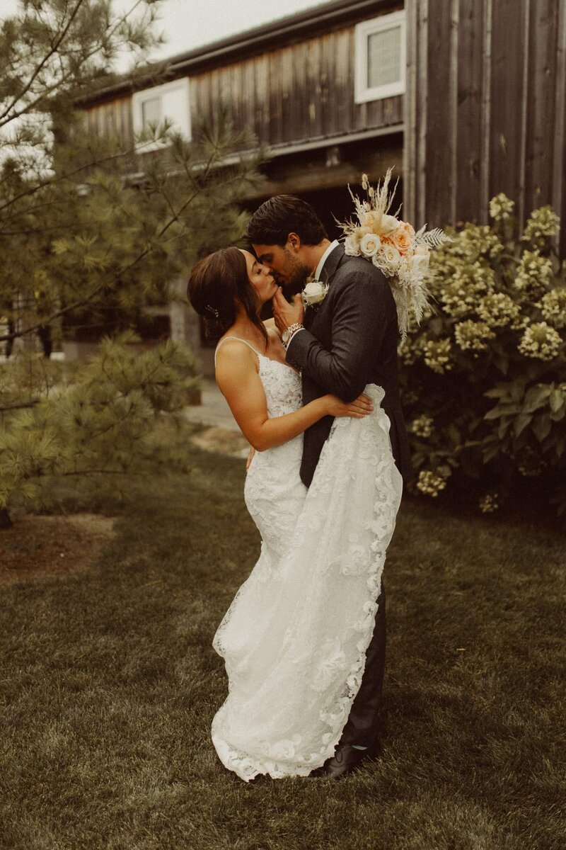 a groom and bride kissing in their marriage