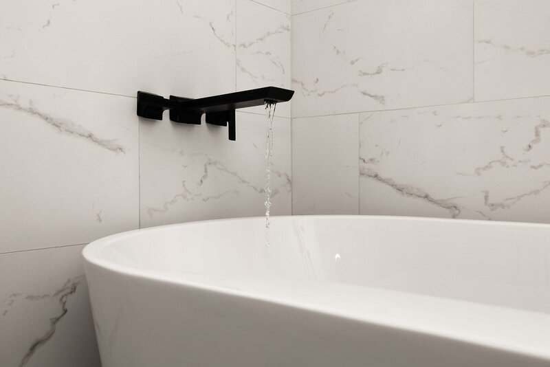 modern bathroom with porcelain tile and matte black tub faucet