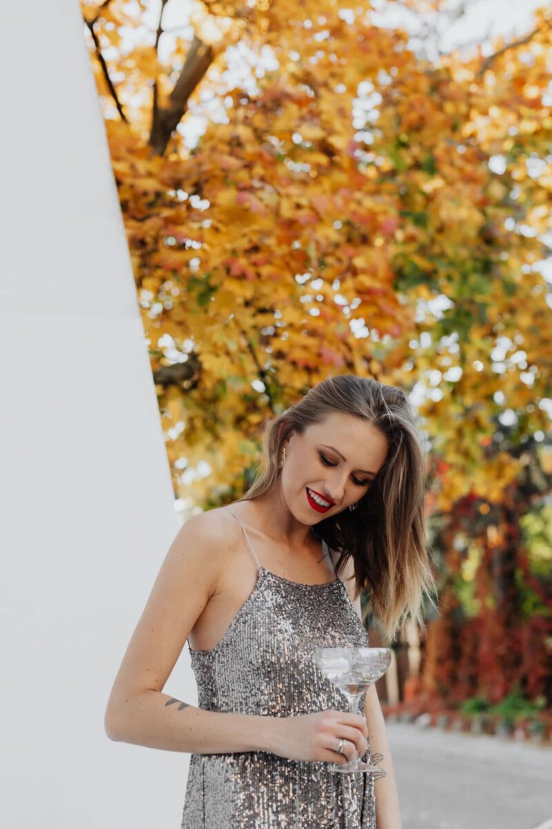 kaboompics_blond-woman-in-a-sequin-dress-is-holding-a-glass-of-champagne-autumn-14692-optimized