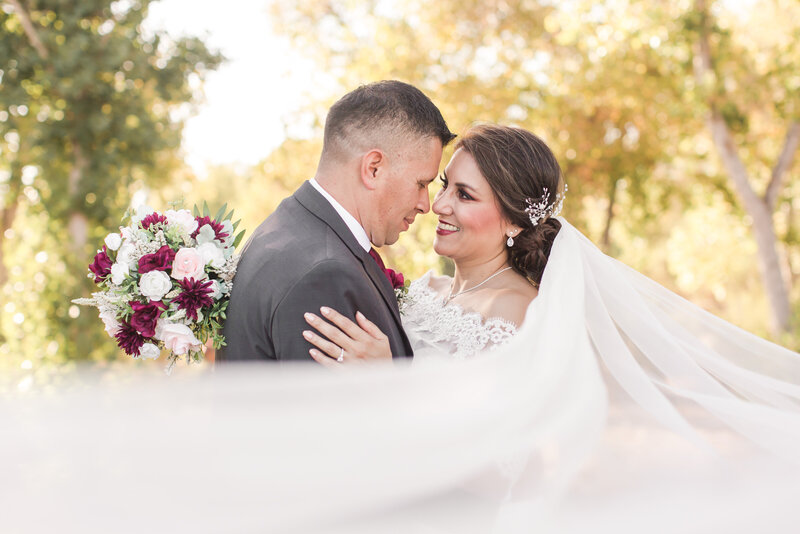 bride and groom at san diego wedding wrapped in veil