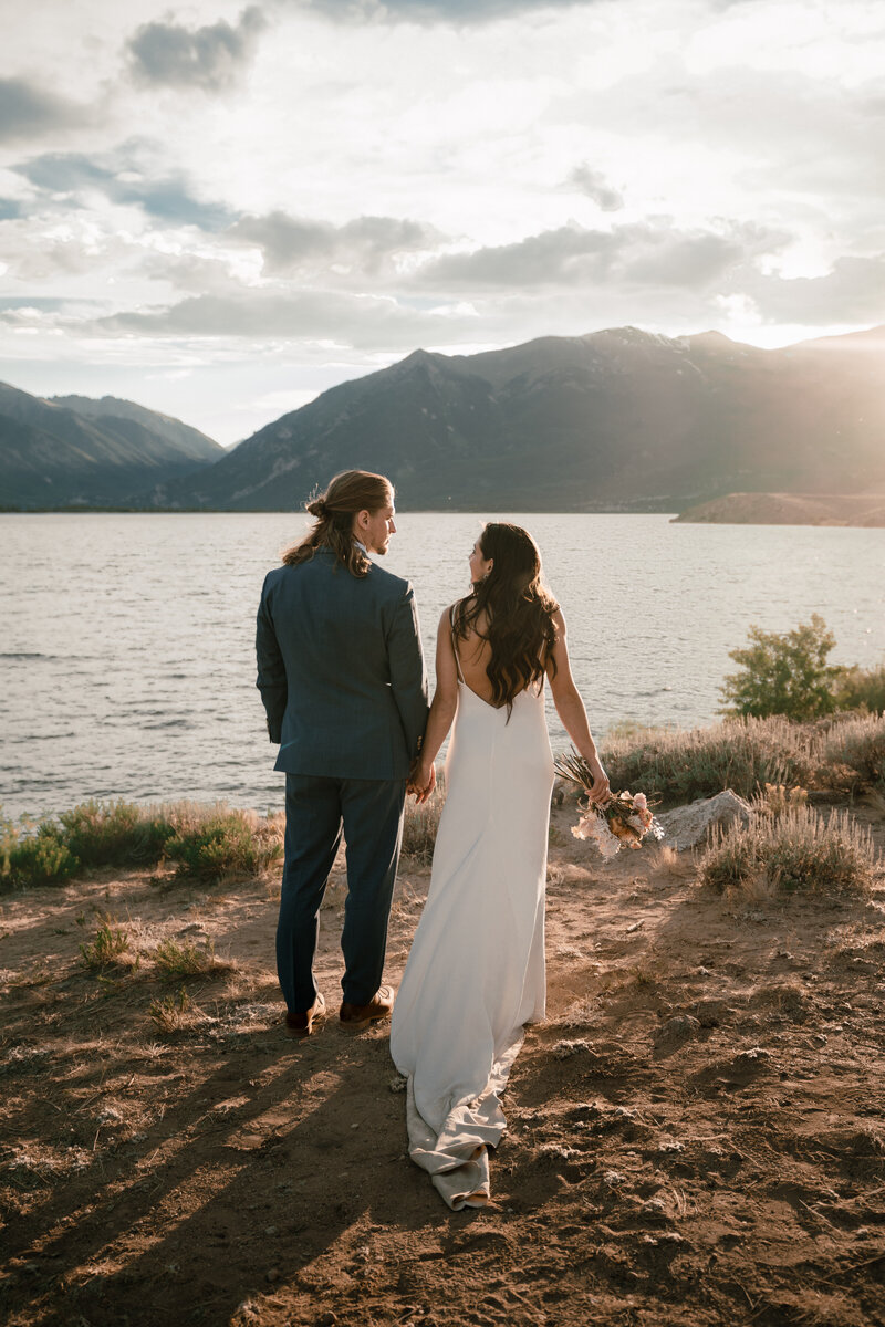 A couple elopes at the Twin Lakes resevoir near Leadville Colorado