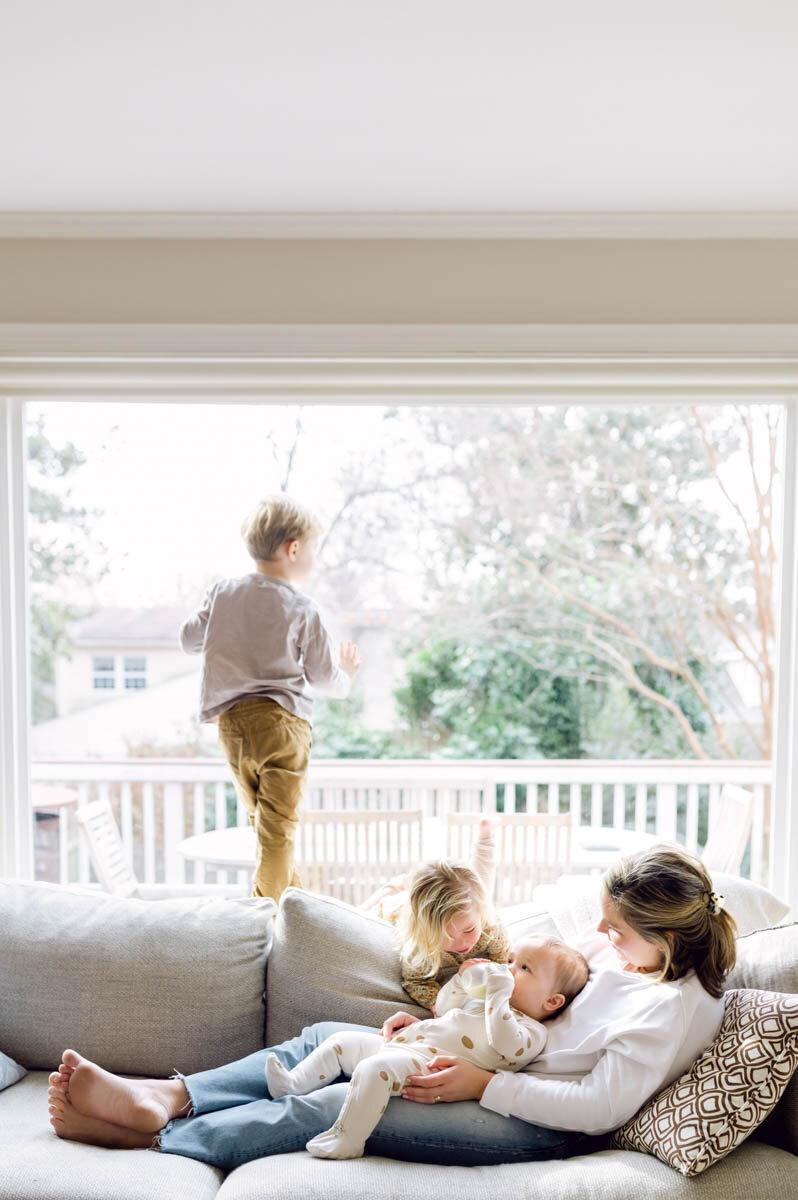 mom with kids on a sofa in their home in The Palisades, Washington DC
