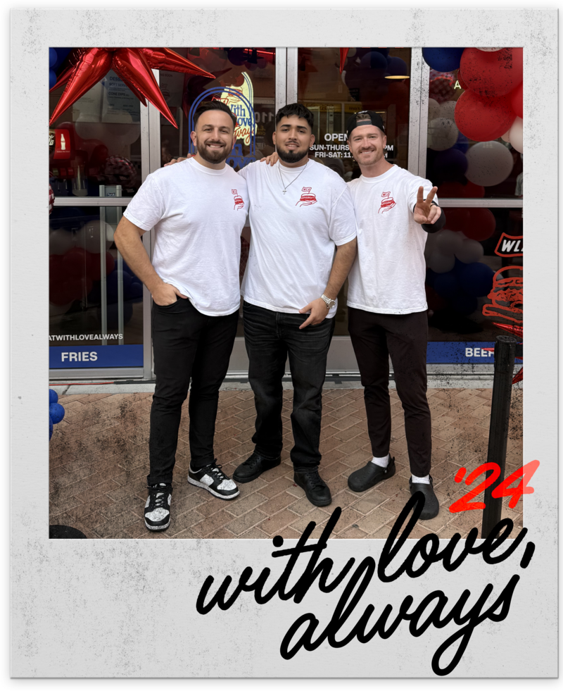 Founders Kevin Whelan, Drew Belcher, and Damian Ocampo Jr. standing in front of With Love, Always restaurant in Las Vegas, wearing white logo t-shirts, 2024