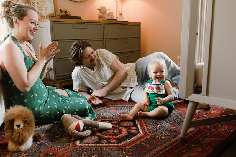 Mother and father on floor with baby in their home, family photographer Austin