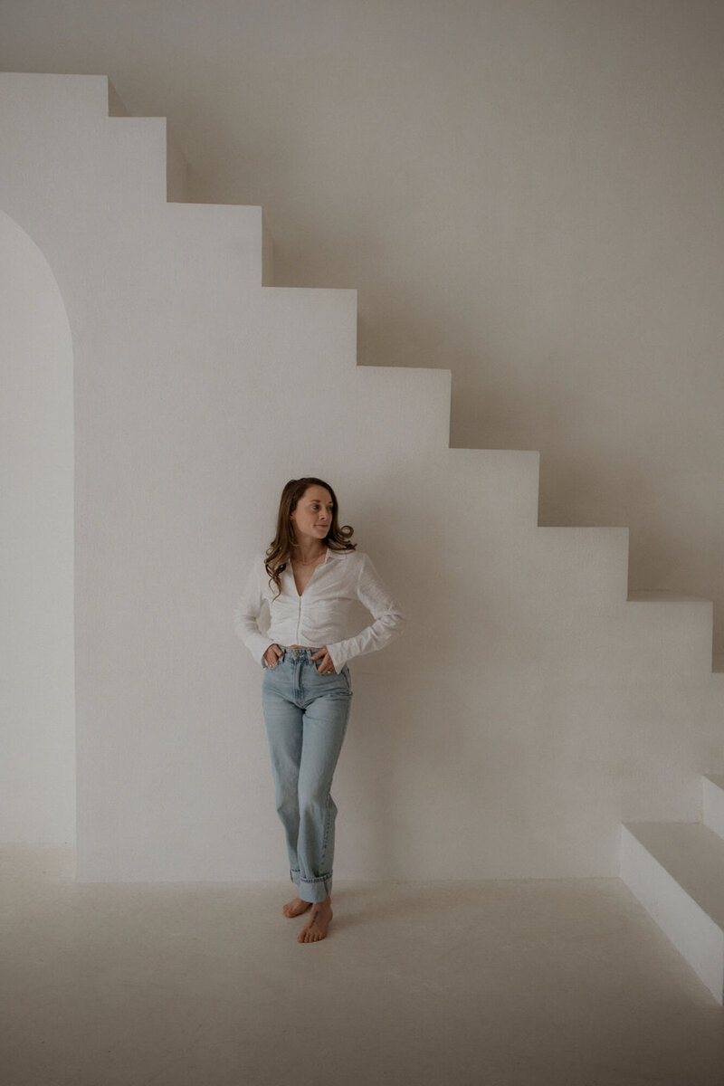 Chelsea Gurr leaning against a plaster staircase