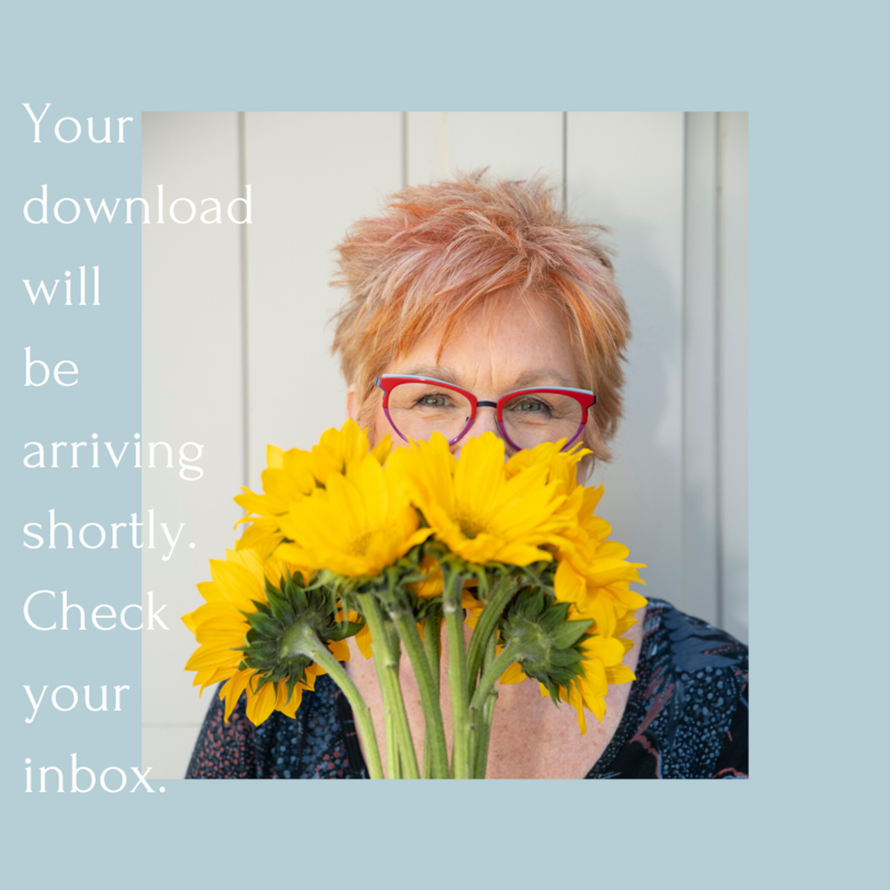 Positively Jane with Flowers standing next to a wall