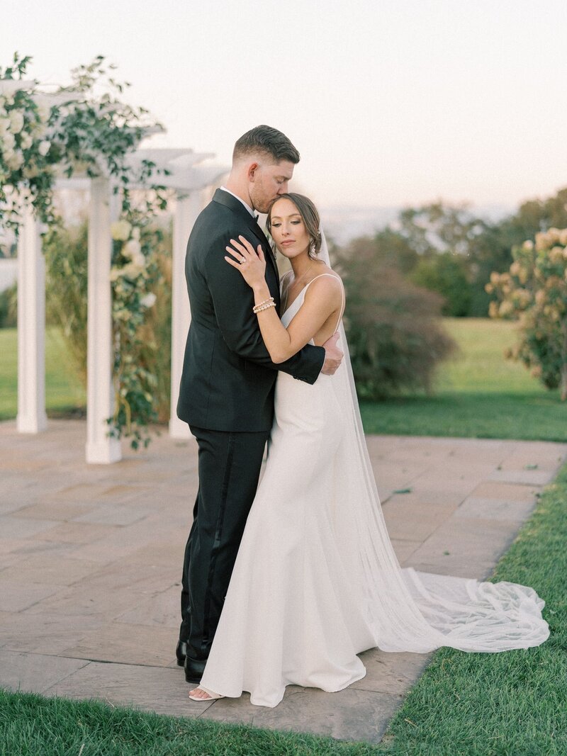 Bride and groom embracing coastal New England wedding
