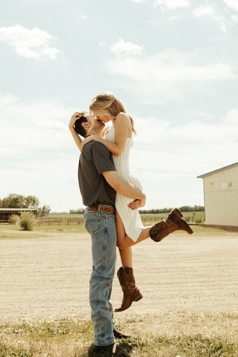 engaged couple kissing