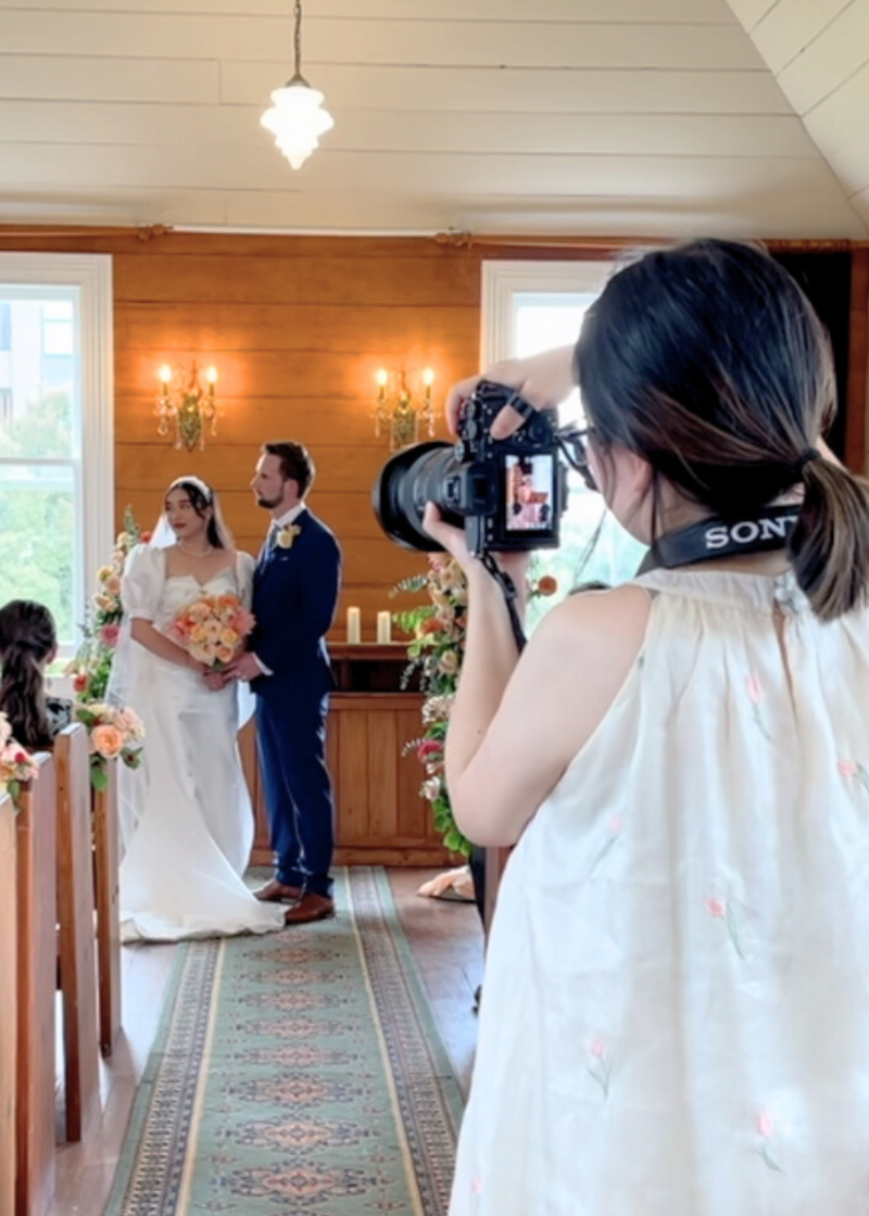 Wedding photographer auckland capturing a bride and groom inside a romantic chapel ceremony with celebrant auckland