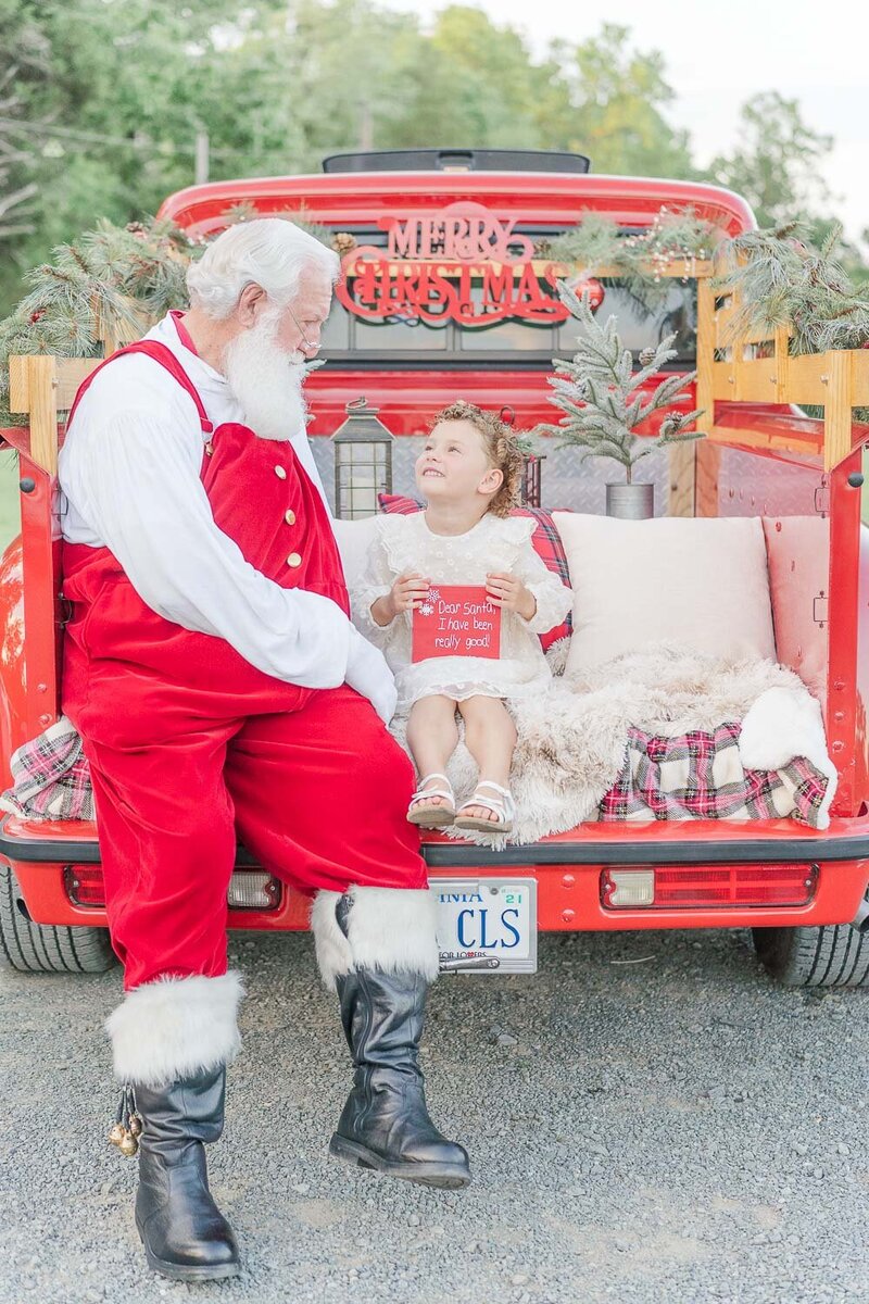 girl talking to Santa taken by a  Fairfax County, Virginia red truck minis photographer