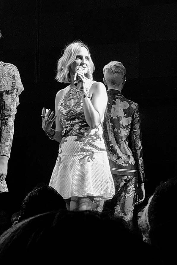 Master hairdresser Katy Reeve presenting on stage during a creative production event, showcasing expertise in professional hairdressing.