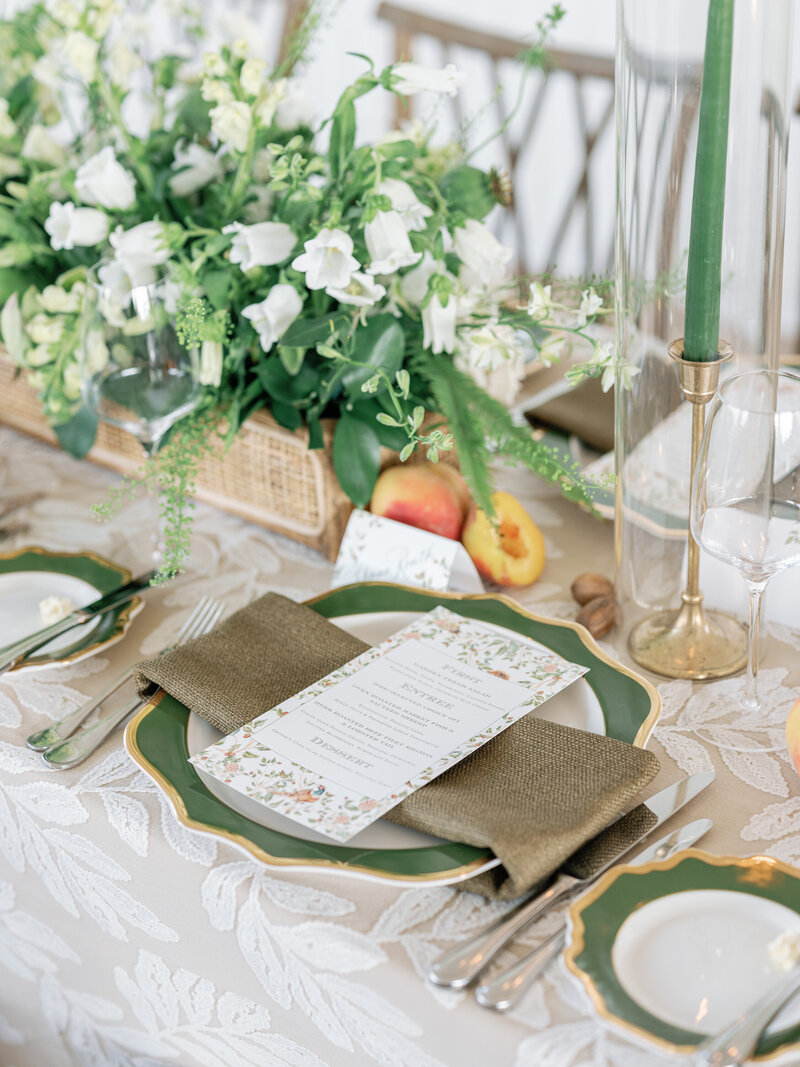 Place settings and lush floral centerpieces at wedding rehearsal dinner