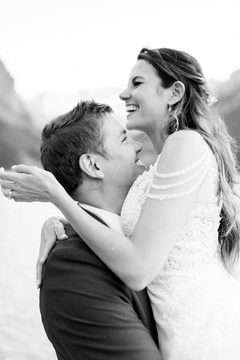 Capture the exhilarating moment of a bride and groom walking away from a helicopter as it takes off during their winter mountain wedding, with snow swirling around them. A breathtaking and adventurous scene of love and excitement.