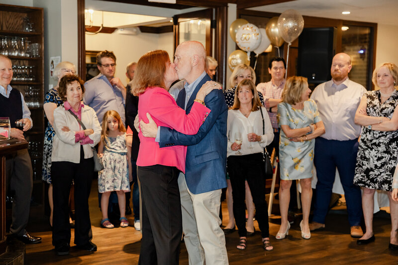 Anniversary couple dancing while guests watch
