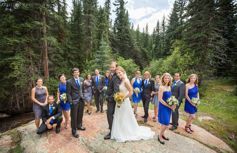 Wedding party pose on a large rock at Mountain View Ranch in Pine