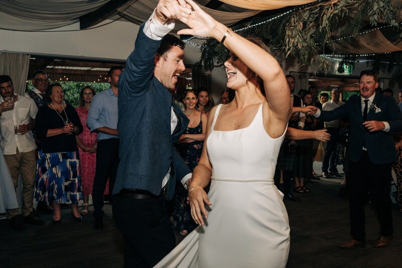 candid shot of bride and groom dancing at mt vernon lodge in akaroa