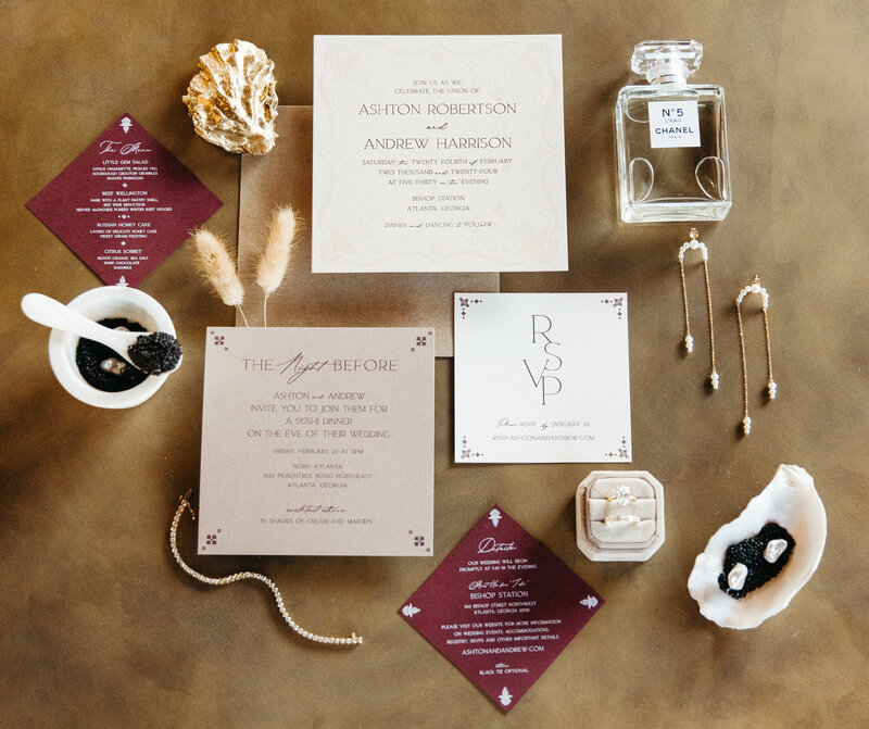 Wedding invitation flatlay with RSVP cards, perfume, jewelry, and modern coastal details on neutral background