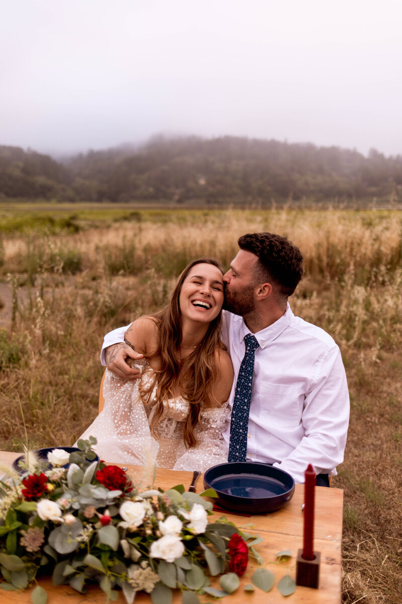 couple kissing each other in field