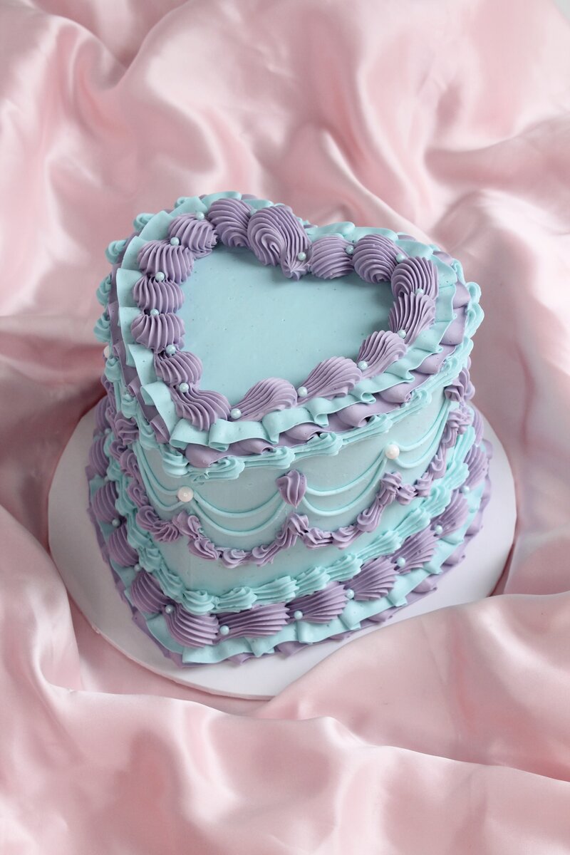 Pink cake with frosting and gold butterflies