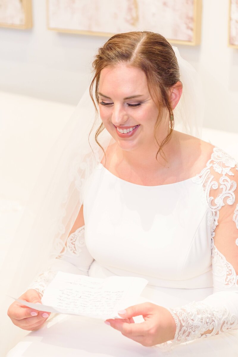 Cecilia smiles at a note she's holding in the Distillery's bridal suite.