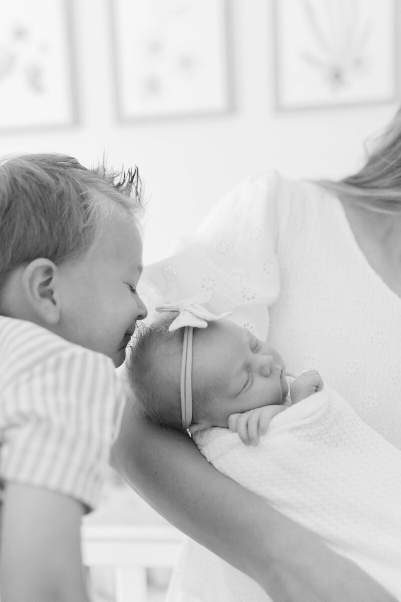 Natural lifestyle newborn session in a soft white nursery—captured by South Jordan newborn photographer.