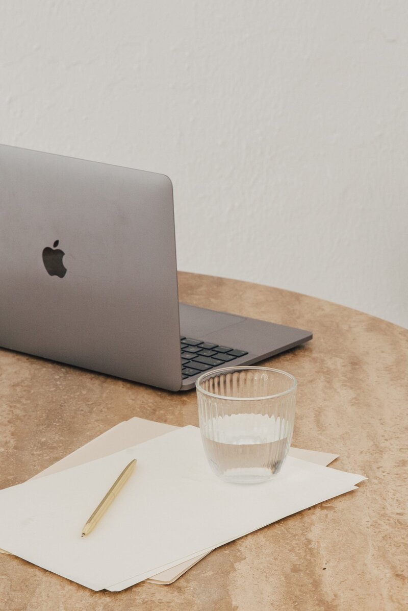 A woman sitting next to a laptop.