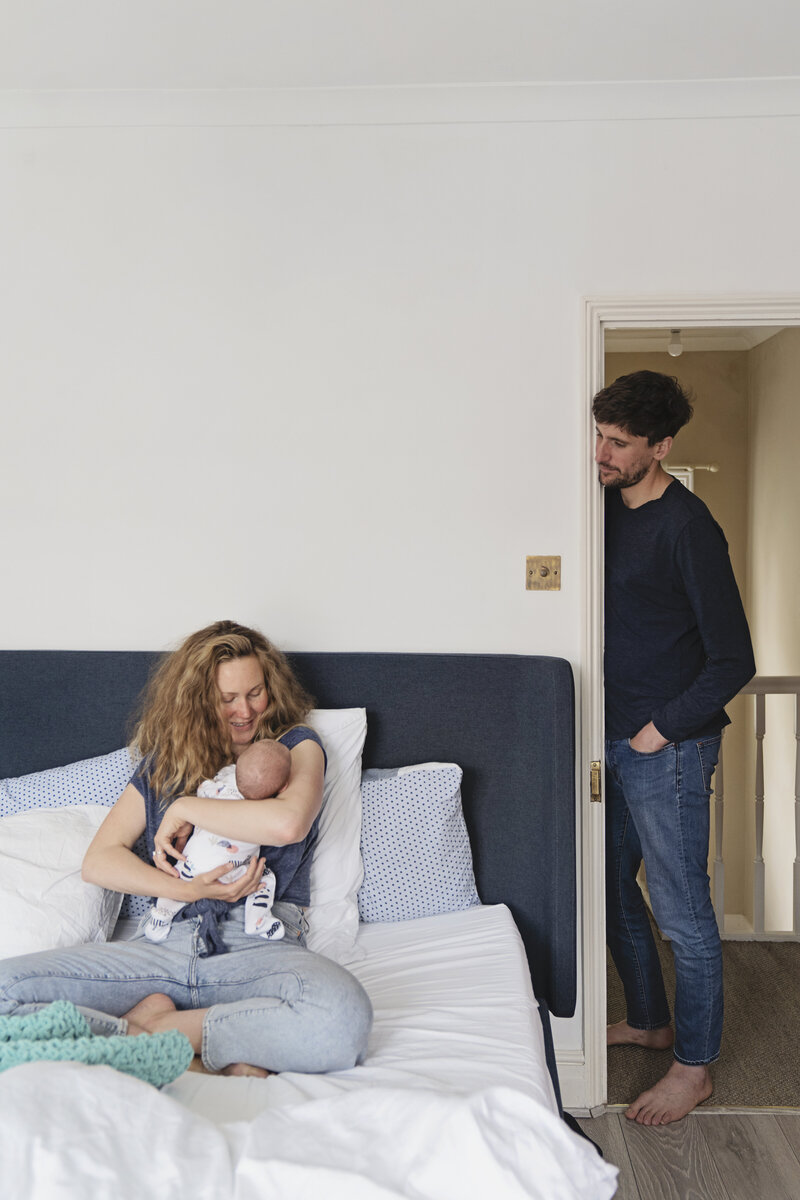 An at home newborn photo shoot with parents and new baby in Teddington, Richmond upon Thames