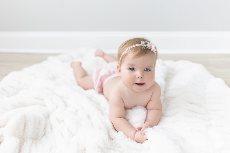 Baby laying on soft blanket in studio